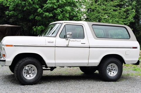 1988 Ford Bronco - This 1978 Ford Bronco is shown from the side, a white body and a grey removable top.