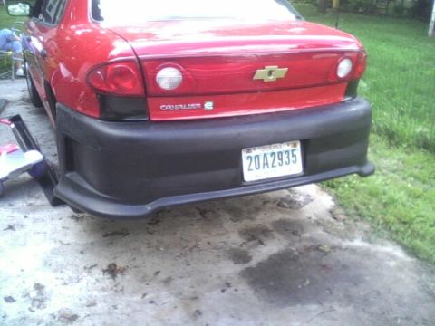 2005 Chevrolet Cavalier - Rear view of a red 2005 Chevrolet Cavalier showing an aftermarket bumper and license plate.
