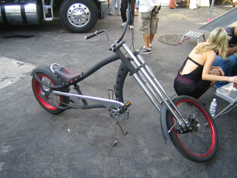 Custom chopper bicycle with red rims and a black frame