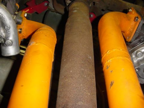 1995 Ford Mustang - Underside view of exhaust pipes and driveshaft, likely from a performance vehicle.