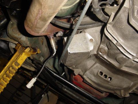 1995 Ford Mustang - Underside view of a vehicle's exhaust system and transmission components, with an oxygen sensor visible.