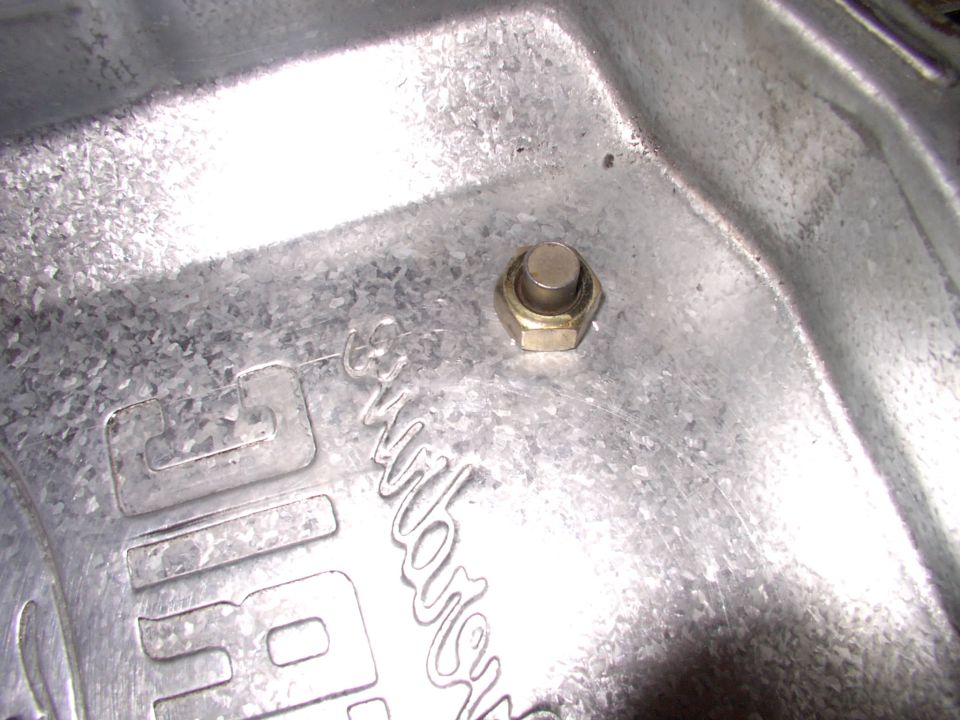 Simply snug the nut to the inside of the pan, using an old drain bolt and the plastic washer on the other side. The reason is  without the washer, which will melt, we welded the bolt to the pan !