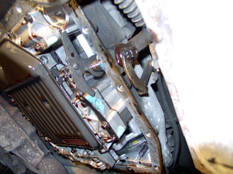 1990 Lincoln Town Car - After twisting out about 10 or so bolts with a 10 mm socket, the pan drops and you get your hair washed in ATF. Some of the fluid goes into…