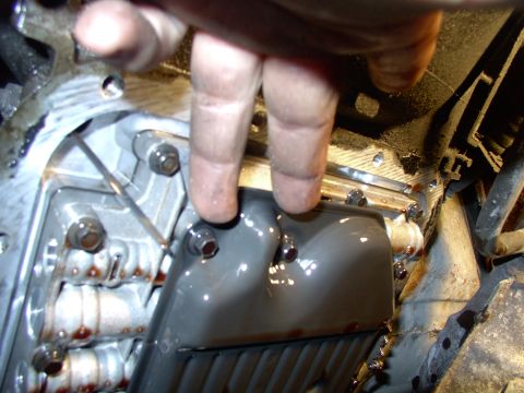 1990 Lincoln Town Car - There's two of the filter bolts. Expect a second deluge of fluid when you remove the filter from the valve body. Your hair has been warned !