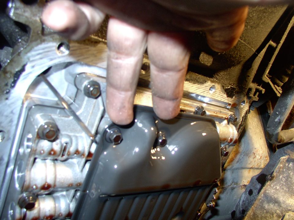 There's two of the filter bolts. Expect a second deluge of fluid when you remove the filter from the valve body. Your hair has been warned !