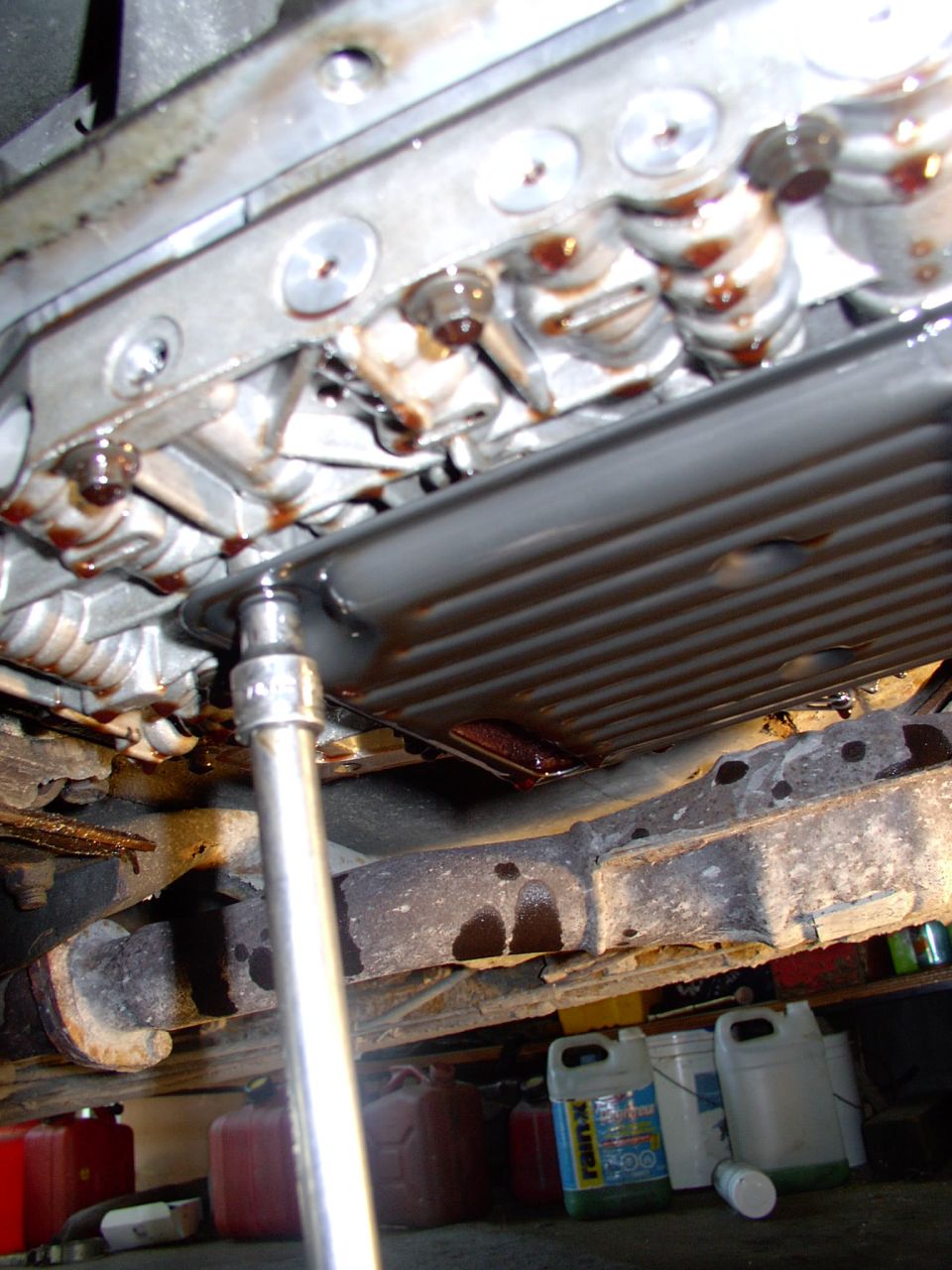 There's the third and last filter bolt coming off, here's comes some more ATF.
