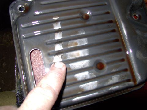1990 Lincoln Town Car - With the old filter out on the bench we can see the slight film built up on the filter housing and the dirty paper element through the slit…