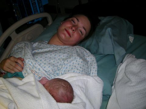 2003 Jeep TJ - A mother cradles her newborn baby shortly after birth, a tender moment captured in the hospital.