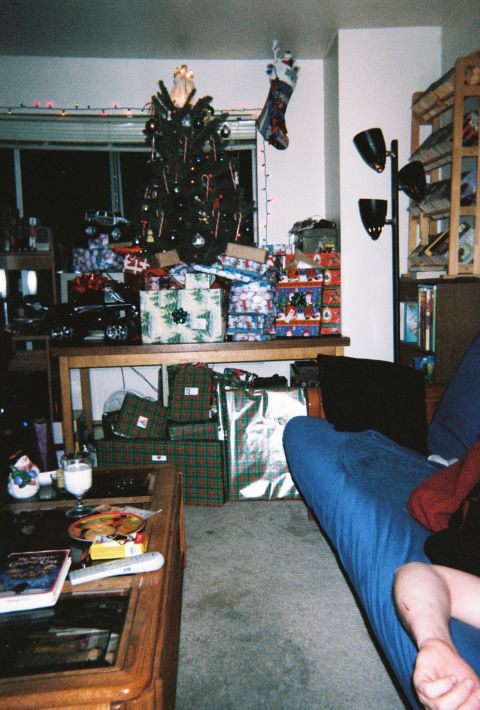 1990 Ford Bronco - A living room scene with a Christmas tree and many wrapped gifts under it.