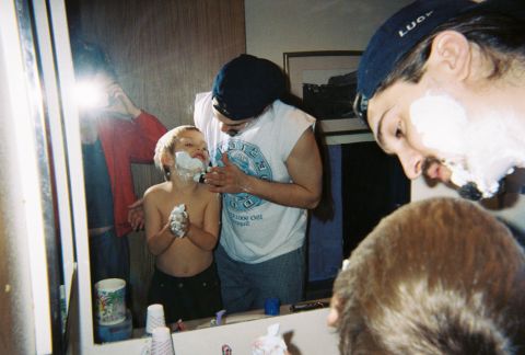 1990 Ford Bronco - A father and son, along with another person, are seen shaving in a bathroom mirror.