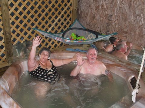 1966 Ford Ranchero - Several people enjoy a soak in a hot tub, with a hammock suspended above.