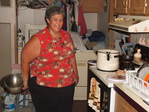 1966 Ford Ranchero - A woman smiles in a kitchen filled with laundry, appliances, and cooking items.