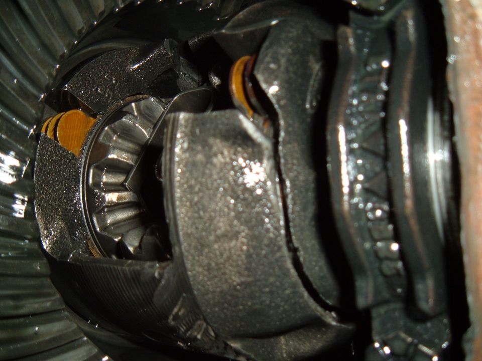 close-up of damaged differential gears with metal shavings