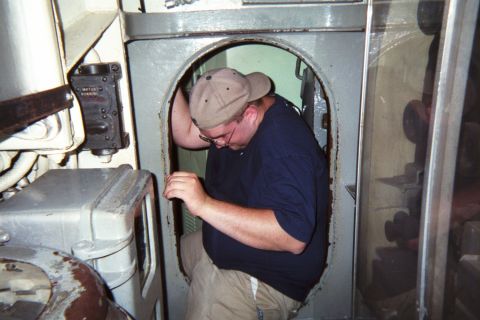 1998 Ford Taurus - A man is seen entering a doorway within a metallic structure, with the Supermotors logo visible in the lower right corner.
