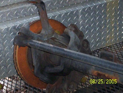 1989 Ford Bronco - A close-up view of a vehicle's suspension component, showing rust and wear.
