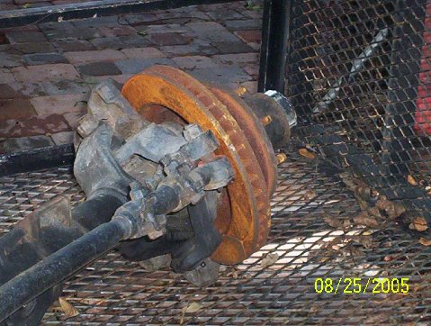 1989 Ford Bronco - Close-up of heavily rusted brake rotor and suspension parts, with a date stamp of 08/25/2005.