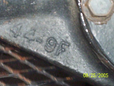 1989 Ford Bronco - Metal part with cast numbers '4-95' visible, along with a hex bolt head.