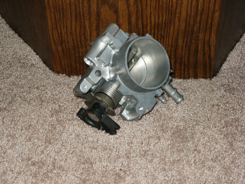 Aluminum throttle body with throttle plate and TPS on carpet