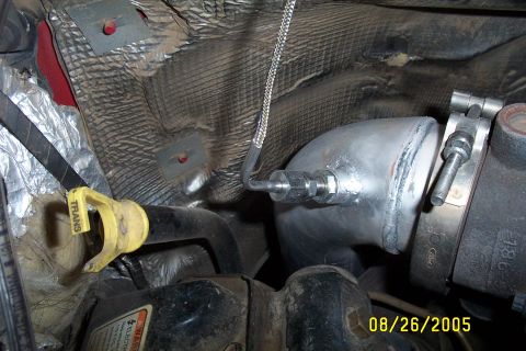 1995 Ford F-350 - Close-up view of an exhaust pipe with a sensor, a visible date stamp from 2005.