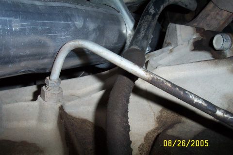 1995 Ford F-350 - Engine bay detail showing various hoses and metal tubing connected to engine components.