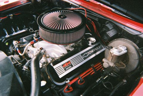 1996 Ford F-150 - The engine bay features a Chevrolet 454 big-block engine with a prominent air filter and custom spark plug wires.