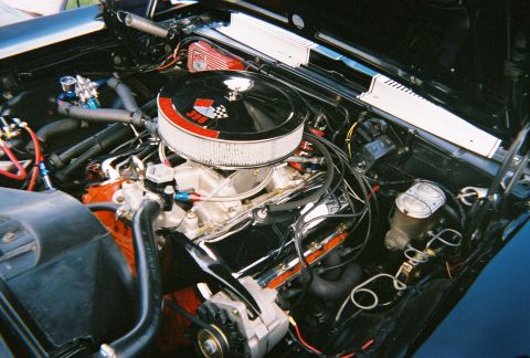 1996 Ford F-150 - Customized engine bay a chrome air cleaner with a checkered flag emblem and "350" designation.