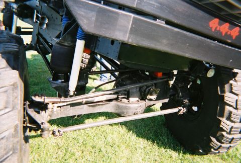 1996 Ford F-150 - Detail shot of a truck's 4x4 drivetrain and suspension components. Supermotors.net logo is present.