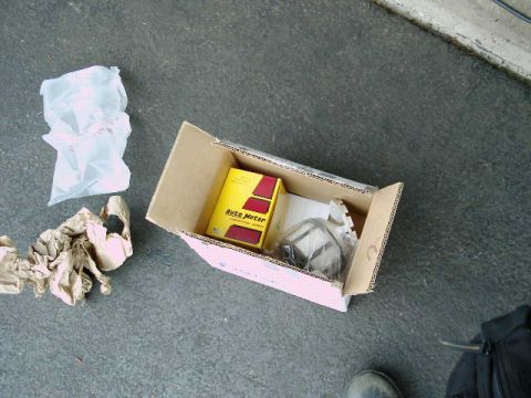2002 Ford F-250 - An Auto Meter gauge is shown inside its shipping box, placed on a concrete surface.