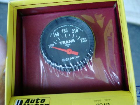 2002 Ford F-250 - A close-up of an Auto Meter transmission temperature gauge is shown inside its packaging.