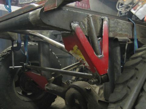 1994 Ford Bronco - Close-up view of a heavily modified vehicle chassis, focusing on suspension and drivetrain components.