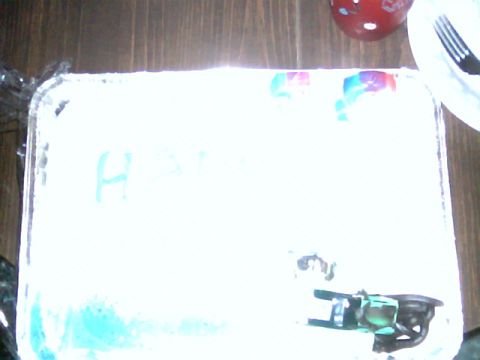1992 Ford Bronco - A cake with blue frosting and the letter 'H' written in icing is visible, along with a fork and plate.