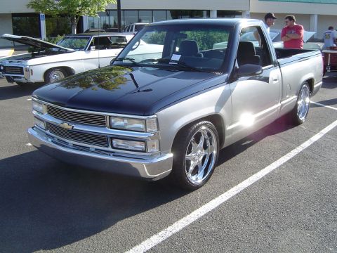 1964 Ford Fairlane - Pickup truck with two-tone paint and custom wheels is parked in a lot next to another vehicle.