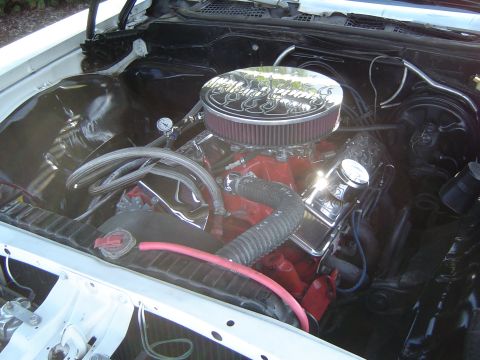 1964 Ford Fairlane - Close-up of a V8 engine in a vehicle's engine bay, chrome accents and an air filter.