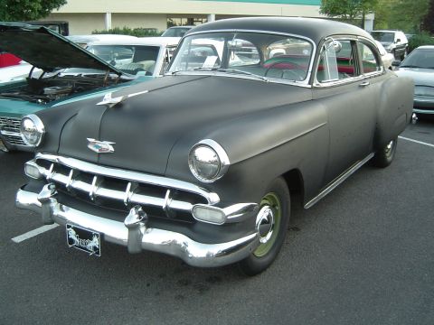 1964 Ford Fairlane - This black sedan, likely from the 1950s, does not match the 1964 Ford Fairlane claim.