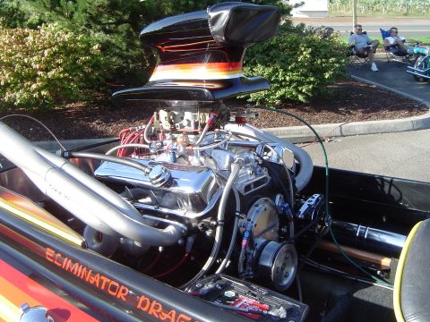 1964 Ford Fairlane - A powerful boat engine with a large blower and custom exhaust pipes is visible, along with the boat's name, "Eliminator Drag".