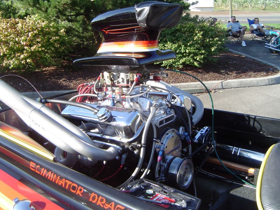 Dragster's exposed V8 with striped scoop hat, chrome valve covers and headers