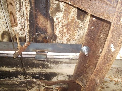 1979 Ford F-150 - Close-up view of the underside of a vehicle, showing rust and a newly welded metal bracket.