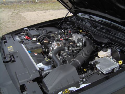 2000 Ford Crown Victoria - The engine bay of a 2000 Ford Crown Victoria is shown with the hood open.