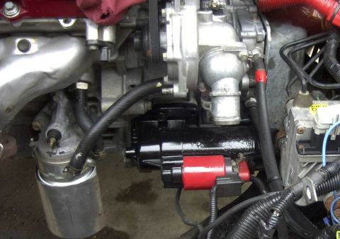 1997 Ford Taurus - I replaced the OEM ATX cooler lines with brass hose barbs and 3/8" hose. Ran it under the upper radiator hose to the front.