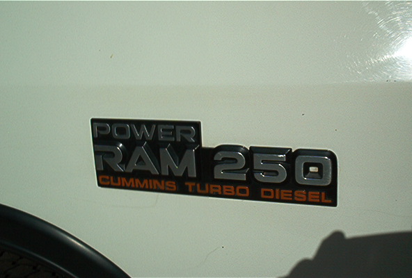 Power Ram 250 Cummins Turbo Diesel fender badge on a white truck body panel