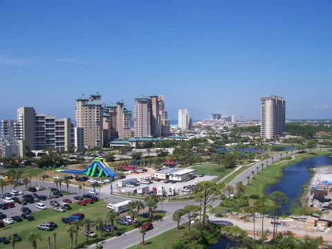 1995 Ford Bronco - View of a coastal city tall buildings, a busy parking lot, and a scenic waterfront area.