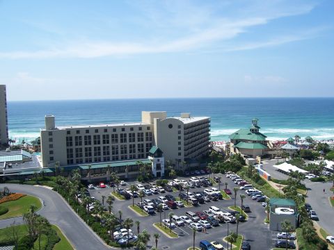 1995 Ford Bronco - A wide view of a hotel and its parking lot adjacent to a beach and the ocean.