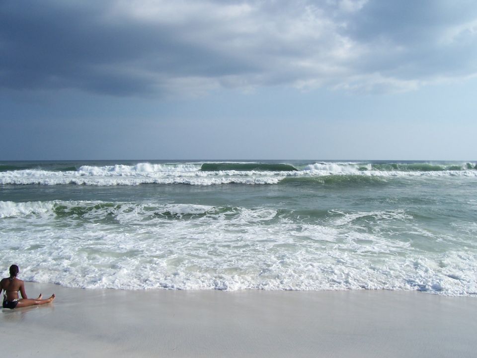 Person on beach with waves and Supermotors logo