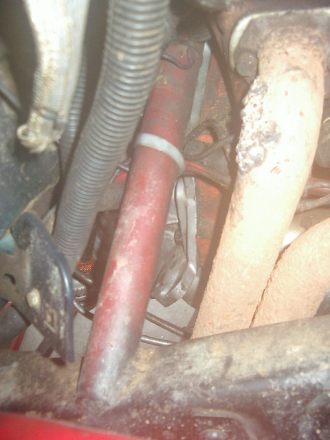 1985 Ford Bronco - This image shows a section of an engine bay with various hoses and exhaust components visible.