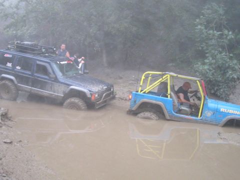 1992 Ford Bronco - Two off-road vehicles are stuck in the mud during an off-road excursion.
