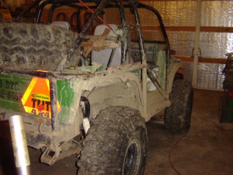 1992 Ford Bronco - This heavily modified off-road vehicle is covered in mud, suggesting recent use on rough terrain.