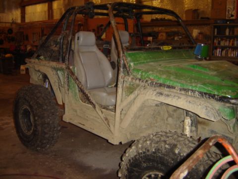 1992 Ford Bronco - This heavily modified off-road buggy is covered in mud, obscuring any identifying year markers.