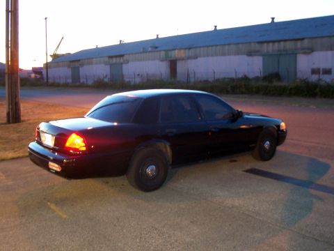 2003 Ford Crown Victoria - Black 2003 Ford Crown Victoria seen from the rear quarter angle at dusk.