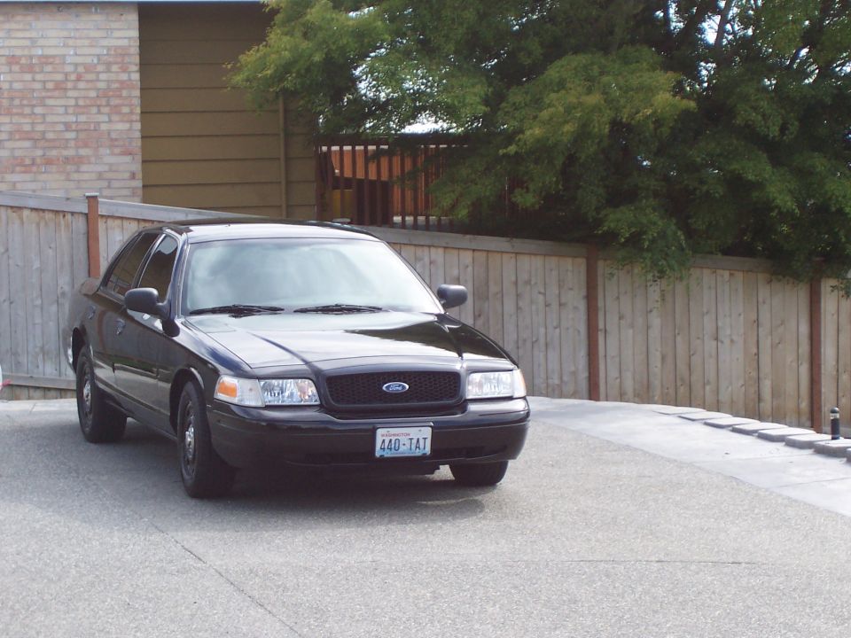 Black 2003 Ford Crown Victoria parked in driveway