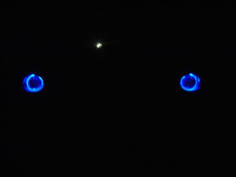 1998 Ford Taurus - Two blue glowing rings are visible against a black background, with a small light source above.